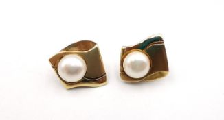 A pair of Mikimoto pearl earrings set into 14k gold mounts (one post bent). 6g gross