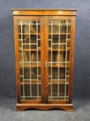 A mid century oak bookcase with leaded glazed doors. H.135 W.80 D.30cm.