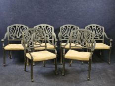 A set of six contemporary metal alloy garden chairs in 19th century style each fitted with a squab