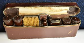A vintage bakelite gentleman's travelling grooming set in a leather case. H.14 W.35 D.5.5cm