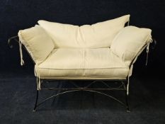 A contemporary wrought iron garden or conservatory canape bench with loose cushion upholstery. H.