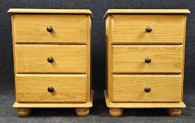 A pair of contemporary pine bedside chests. H.60 W.45 D.36cm.