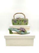 A papier-mache hand made model shoe with applied floral decoration, along with and a colour