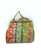 A papier-mâché model handbag with sequinned decoration, indistinctly signed. L.19 H.18.5cm