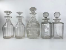 A pair of Georgian decanters with stoppers, a cut glass single Georgian decanter and another pair of