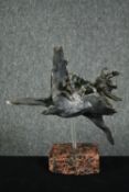A mid century glazed figure of a horse in flight raised on a marble base. H.24 W.26cm.