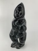 A carved stone Inuit figure. H.33cm