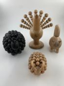 Four carved pine AArikka of Finland figures; a peacock, a cat and two rams. H.22cm (largest)