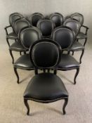 A set of ten Louis XV style dining chairs upholstered in faux leather, to include two carver