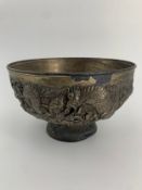 A Japanese bronze bowl with all over dragon decoration. Dia.23cm