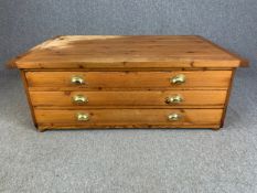 A pine coffee table from the top section of a plan chest. H.47 W.125 D.84cm.