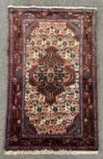 An Afshar rug with central stylised lozenge medallion on biscuit ground within spandrels and