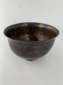 A 19th century Qajar copper and metal rimmed bowl. Dia.17cm