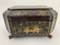 An early 19th century hand decorated and lacquered Chinoiserie box on brass lion's paw feet. H.14