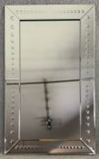 A contemporary glass framed wall mirror. H.153 W.91cm