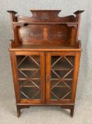 A C.1900 pitch pine display cabinet in the Arts and Crafts style. H.140 W.84 D.32cm.