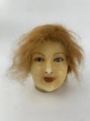 A wax doll's head, 19th century French. H.22cm