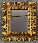 A small Florentine style carved wall mirror. H.40 W.35cm