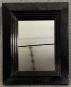 A contemporary moulded frame wall mirror. H.82 W.67cm