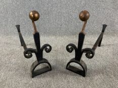 A pair of C.1900 wrought iron and brass fire dogs. H.40 L50cm (each)
