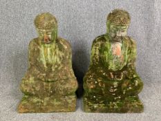 A pair of weathered terracotta garden figures; seated Buddhas. H.62cm (each)
