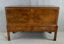 An 18th century walnut and crossbanded chest on stand with hand painted decoration to the inside