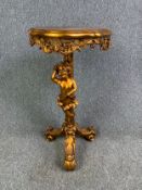 A moulded gilt 19th century Continental style urn stand on figural cherub support. H.77cm