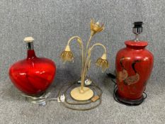 A contemporary coloured glass table lamp, a ceramic Chinese style baluster lamp and a wrought
