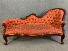 A Victorian style mahogany chaise longue in carved frame and deep buttoned upholstery. H.92 W.186