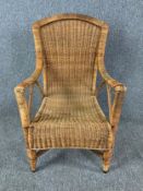 A vintage Sirroni wicker conservatory chair with maker's label to the underside. H.91cm