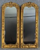 A pair of 19th century style pier glasses in scrolling foliate gilt frames. H.106 W.41cm (each)