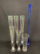 A tall vintage blue glass soliflore vase and a collection of outsized glass vases. H.104cm (largest)
