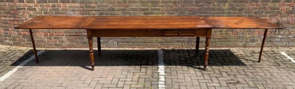 A 19th century French fruitwood farmhouse style refectory dining table with cleated planked top