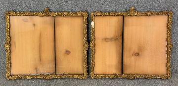 A pair of early 20th century Rococo scrolling gesso picture frames, with glass. H.45 W.52cm (each)