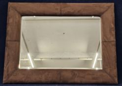 A contemporary faux suede cushion mirror. H.90 W.120cm.