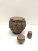 Three early 20th century silver Buddhist lidded jars in the form of a drum. Pierced floral design