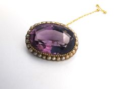 A Victorian yellow metal (tests as 14ct gold) amethyst and seed pearl oval cluster brooch, set