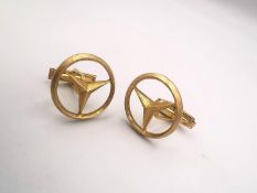 A pair of 14 carat yellow gold Mercedes logo hinged cufflinks, the logo with a brushed effect.