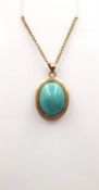 A 14ct rose gold and turquoise pendant on a 17 inch 9ct rose gold trace link chain. The oval pendant