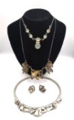 Three boxed bespoke silver necklaces from David Benson of Ludlow, one folded paper design