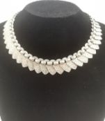 A Victorian white metal (tests as silver) book chain, with shield shaped overlapping links hand