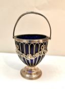 A Victorian pierced silver sugar basket by Haseler Brothers with rose and foliate swag detailing and