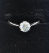 A platinum diamond solitaire ring by Henry Griffith & Sons, set with a round old cut diamond with an