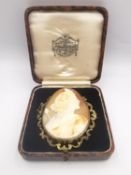 A large Victorian carved shell cameo brooch, the carved shell cameo set in a yellow metal (tests