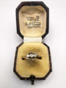 A boxed Edwardian yellow metal (tests as higher than 14ct) three stone diamond ring, set with