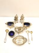 A collection of silver cruets and a pierced bonbon dish, including a five piece cruet set, a