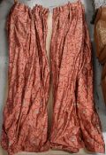 A pair of large silk curtains, lined and with scrolling foliate detail on a rose ground. H.265 W.215