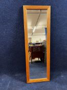 A contemporary oak framed dressing mirror. H.122 W.40 D.3cm