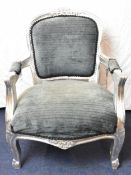 A contemporary French style child's armchair with carved and painted frame. H.66cm