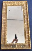 A contemporary gilt wall mirror in the antique style. H.92 W.50 D.5cm